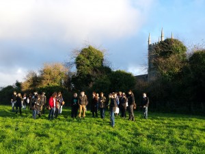 The students viewing the remains of a late-medieval town in County Down.